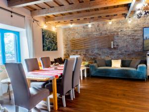 a dining room with a table and chairs at Modern stone house in Balatonfüred with jacuzzi in Balatonfüred
