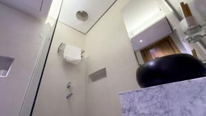 a bathroom with a mirror and a black ball on a counter at منازل صوان للوحدات السكنية in Al Shafa +6 photos