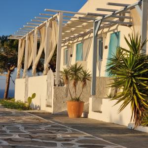 a white house with a pergola and some plants at Bellevue Village ''Αdults Only'' in Agia Pelagia +134 photos