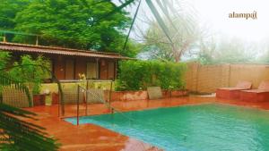 a swimming pool in front of a house at Alampat Nest in Alwar