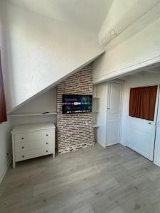 una stanza vuota con una scala e un muro di mattoni di Séjournez face au Château Royal de Blois a Blois