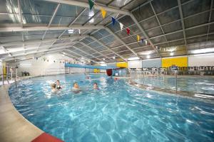 eine Gruppe von Menschen, die in einem Schwimmbecken schwimmen in der Unterkunft Finest Retreats - Joyful Cottage in Saint Erth