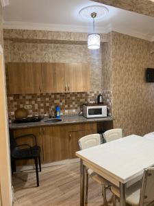 a kitchen with a table and a microwave at Amida&NurayHouseHotel in Istanbul