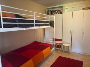 a small room with a bunk bed and two chairs at Lea in Matfors