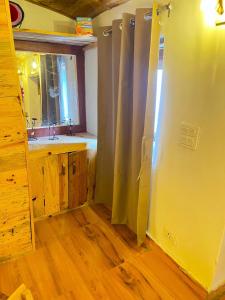 a bathroom with a sink and a shower curtain at Arameh-A Boutique Orchard Retreat Near Kasauli in Rājgarh +52 photos