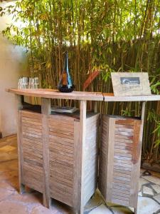a wooden table with a vase on top of it at La Maison Blanche – Plage et centre in Fouras