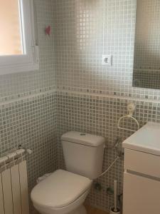 a bathroom with a white toilet and a sink at Cuencaloft Villa Paraíso in Carrascosa del Campo +30 photos