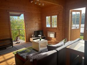 a living room with a couch and a tv at Seehaus Selina in Matfors