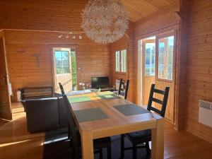 a dining room with a table and a chandelier at Seehaus Selina in Matfors +24 photos