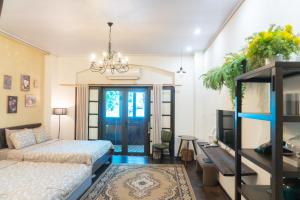 a bedroom with a bed and a tv in a room at Sure Home in Hanoi