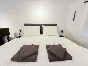 a bed with two brown pillows on top of it at Cave-Salzburg in Salzburg