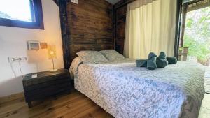 a bedroom with a bed with two teddy bears on it at Mshome La Turquesa in Monachil