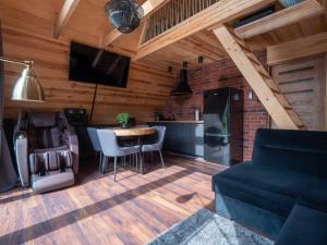 a kitchen and living room with a couch and a table at Chill House in Wierzchucinek