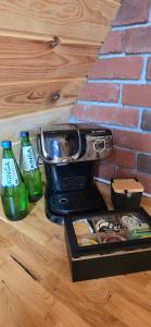 a blender next to a brick wall with two bottles at Chill House in Wierzchucinek