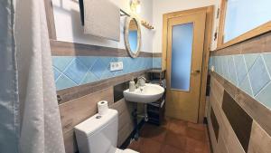 a bathroom with a toilet and a sink at Mshome La Toscana in Monachil +20 photos