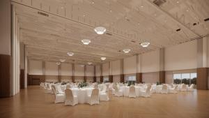 a large banquet hall with white tables and chairs at Arche Metalowiec Muszyna 