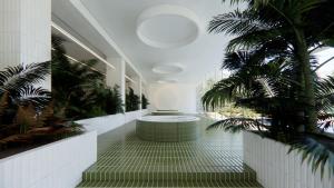 a hallway with a palm tree and a tub in a building at Arche Metalowiec Muszyna 