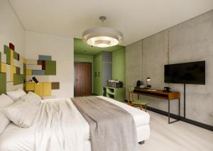 a bedroom with a white bed and a desk at Arche Metalowiec Muszyna 