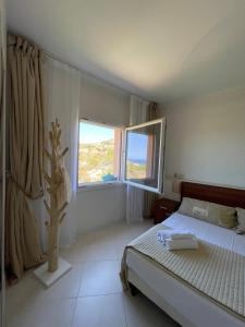 a bedroom with a bed and a window at Splendida vista mozzafiato Costa Rossa Sardegna in Isola Rossa +96 photos