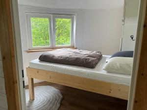 a bedroom with two beds and a window at La petite maison ronde in Salvan