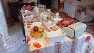 a table with a table cloth with food on it at B&B Au Petit Bonheur in Saint Vincent