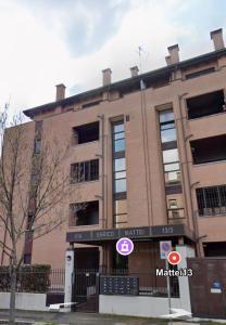 a brick building with a sign in front of it at Mattei13 in Bologna