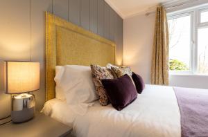 a bedroom with a large white bed with pillows at Landal Aysgarth in Aysgarth