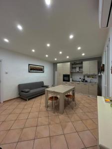 a living room with a table and a couch at Double Spaces Apartaments in Tortona +15 photos
