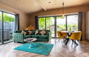 a living room with a green couch and a table at Landal Aysgarth in Aysgarth