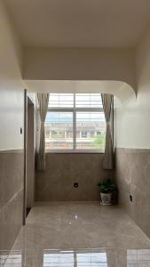 a large room with a large window in a building at Hotel Radhika in Jāmb