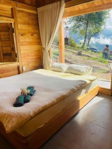 a bedroom with a bed with a teddy bear on it at Samu Retreat Tà Xùa in Bắc Yên