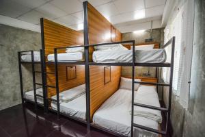 a group of bunk beds in a room at Baan Lung Poshtel in Chiang Mai