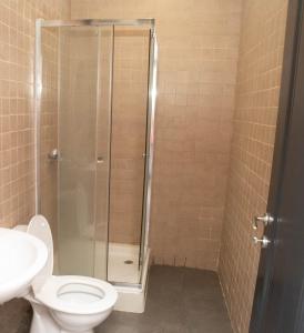 a bathroom with a shower with a toilet and a sink at Nour apartments in São Tomé +31 photos