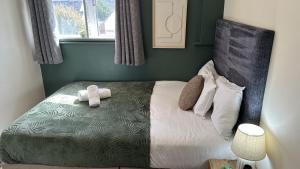 a bedroom with a bed with two towels on it at 1 Double Bedroom-Shared House-Stonehouse-Stroud-Room 3 in Stonehouse