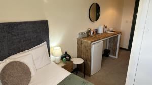 a bedroom with a bed and a desk with a mirror at 1 Double Bedroom-Shared House-Stonehouse-Stroud-Room 3 in Stonehouse