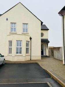 una casa con un coche aparcado delante en Stonehaven, en Ballycastle