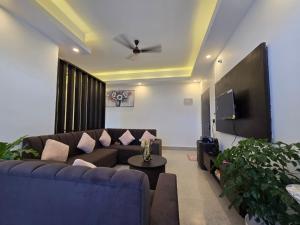 a living room with a couch and a tv at Lir-etso Homestay in Diphu +4 photos