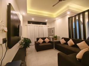 a living room with a couch and a tv at Lir-etso Homestay in Diphu