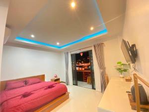 a bedroom with a pink bed and a window at ริมหมอก จาต๋ารักไทย in Ban Rak Thai