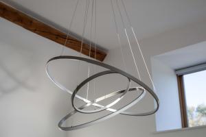 a metal chandelier hanging from a ceiling at The Agora in Mollington