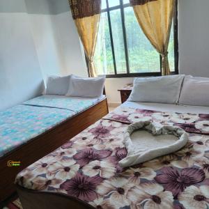 a bedroom with two beds with a heart shaped pillow at Hotel Kailash lumbini in Rummindei +39 photos