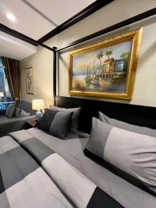 a room with a bed and a painting on the wall at Karon Beach Seaview Penthouse With Private Pool Condominium in Karon Beach +42 photos