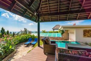 a patio with a pool and chairs and a house at Karon Beach Seaview Penthouse With Private Pool Condominium in Karon Beach