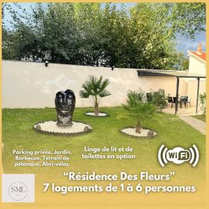 a sign for a garden with a statue at Résidence des Fleurs in Cabourg