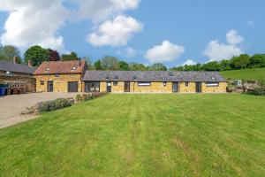 a large brick building with a large grass yard at The Agora in Mollington