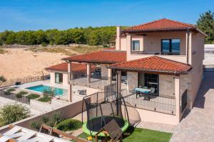 an aerial view of a house with a swimming pool at Luxury Villa Wave heated pool sauna in Sveti Filip i Jakov