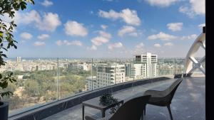 a balcony with two chairs and a view of a city at Soho Boutique Casablanca in Casablanca