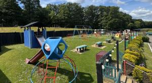 a park with a playground with a slide at The Kings Head Inn in Gloucester
