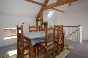 a dining room with a wooden table and chairs at The Stables in Mollington +38 photos