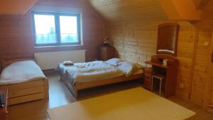 a small room with two beds and a window at Wiślany Raj in Wisła